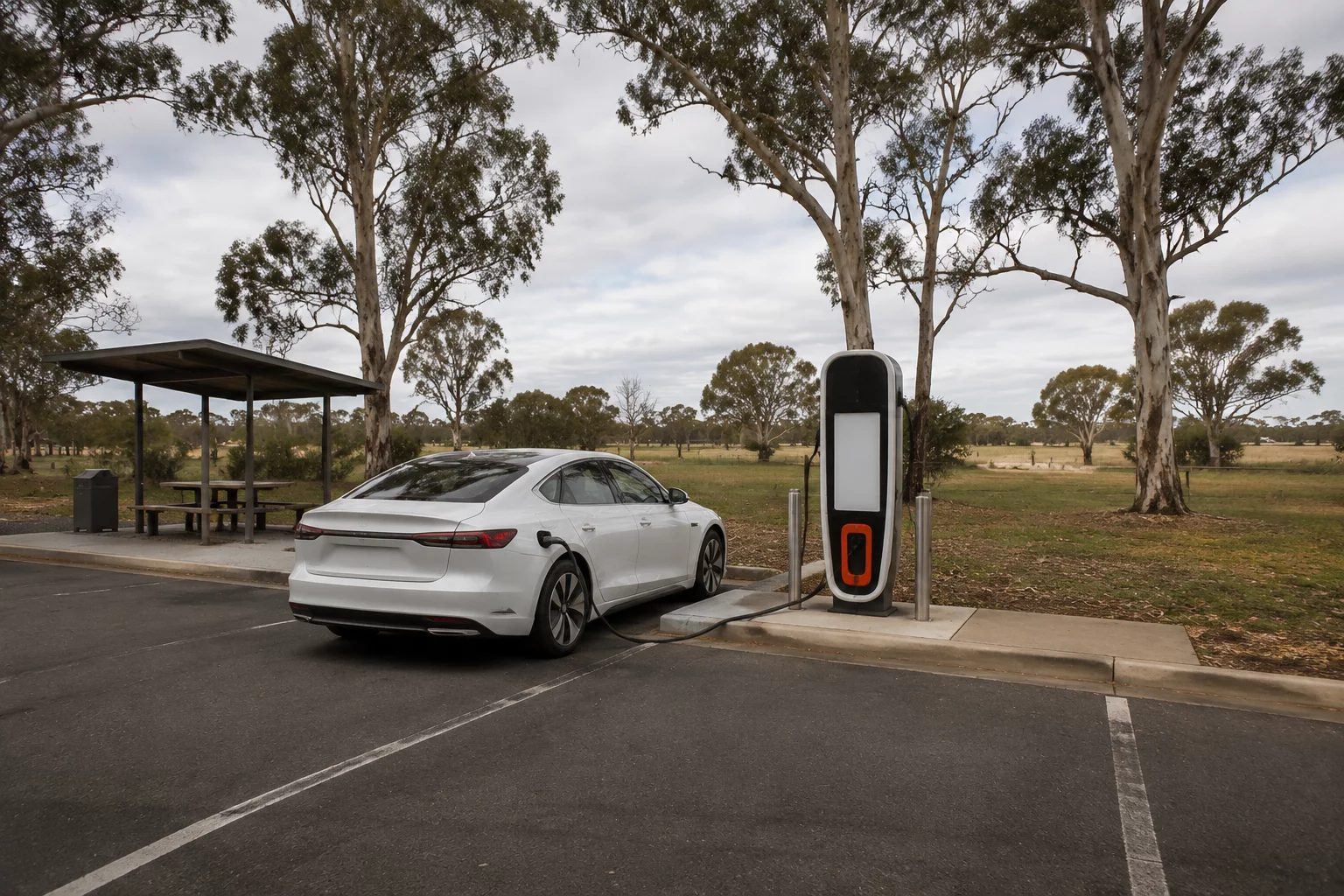 An electric car charging at a roadside fast charger